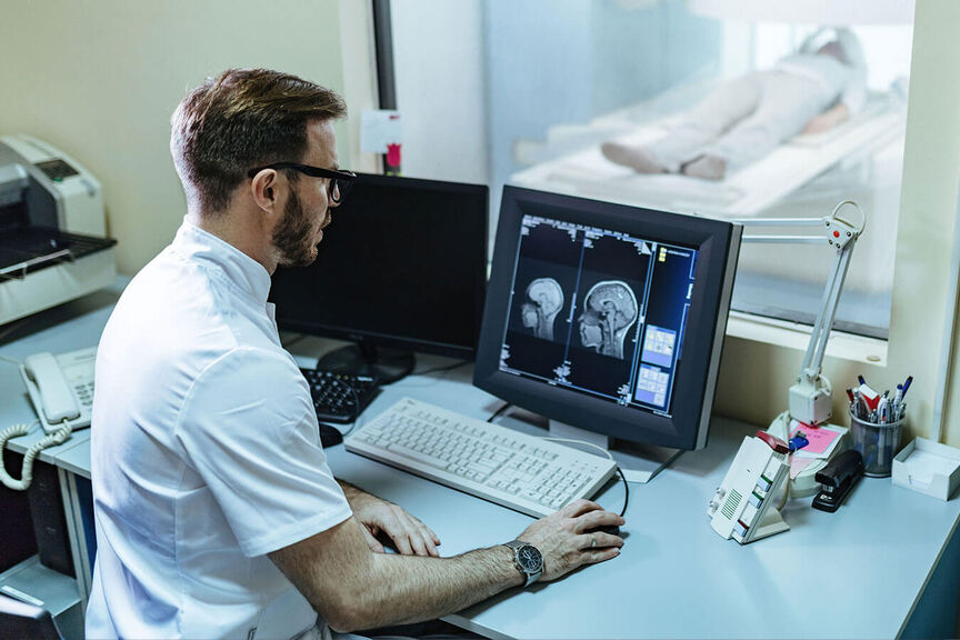 An MRI tech looking at a brain scan