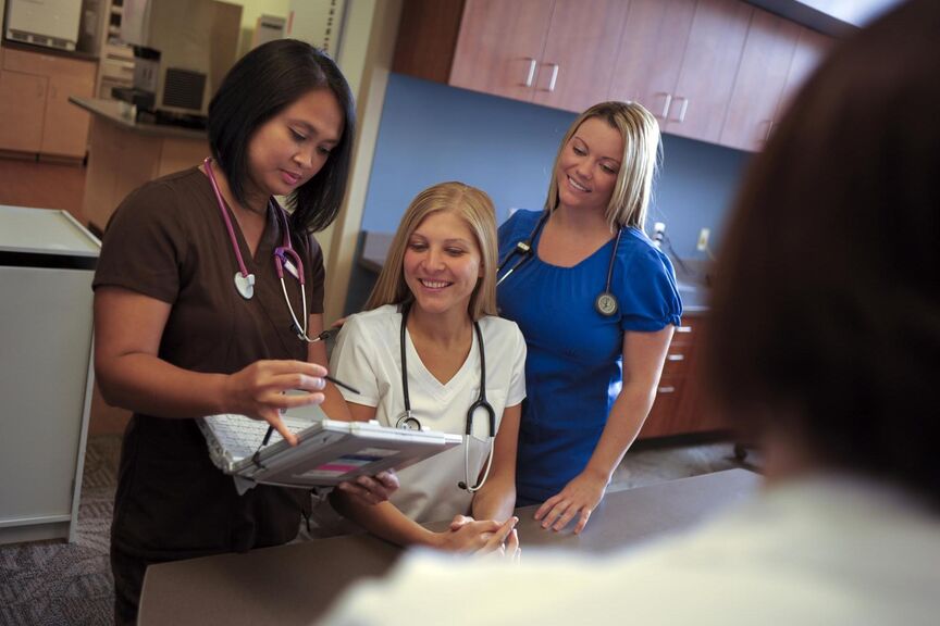 Nurses looking a a computer