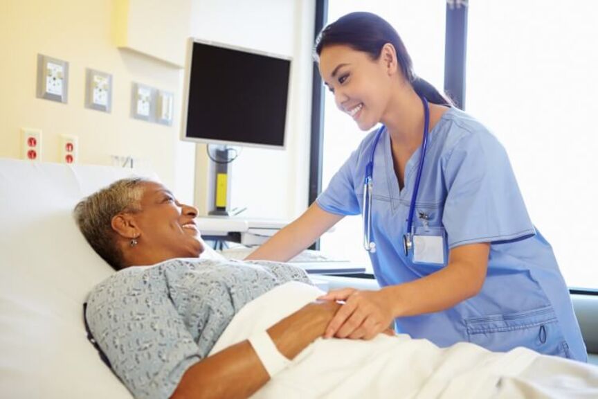 nurse-holds-hand-of-older-patient