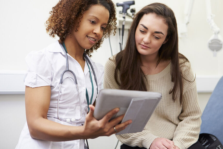 Nurse with patient using tablet