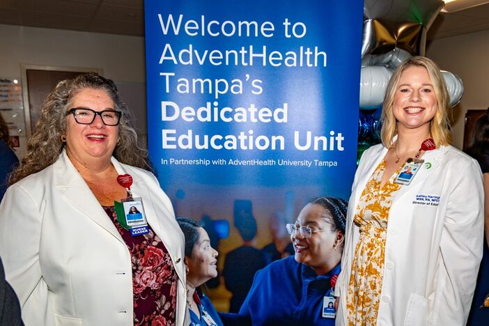 Nursing leaders from AdventHealth Tampa stand in front of the DEU sign