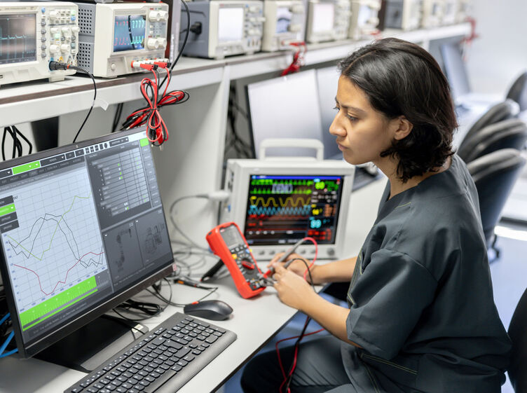 A healthcare technology worker reading a computer screen