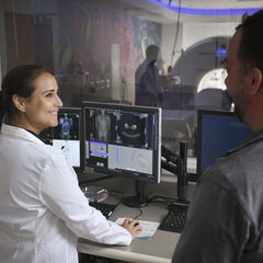 A nuclear medicine technologist conducting a PET scan