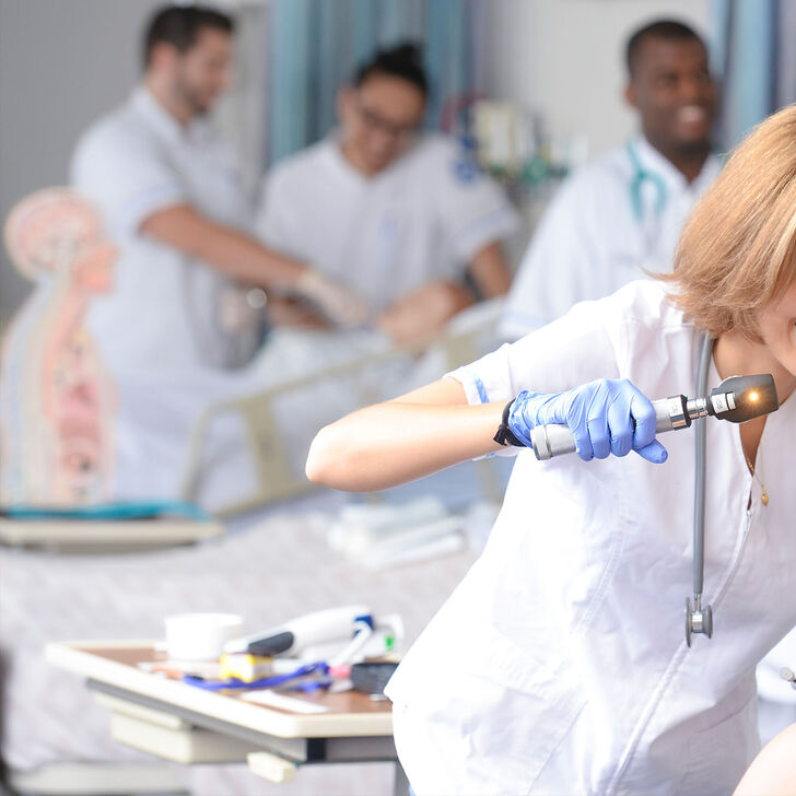 A female nursing student practices patient examinations in our skills lab