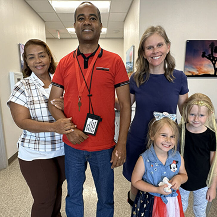 Glexey Caraballo stands with his mother, and Cathy Garrett stands with her daughters. Both Glexey and Cathy performed in STROKESTRA as part of their recovery.