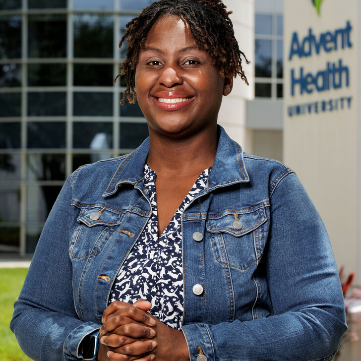 Khandi Stewart-Cooper standing outside the Campus Center building at AHU