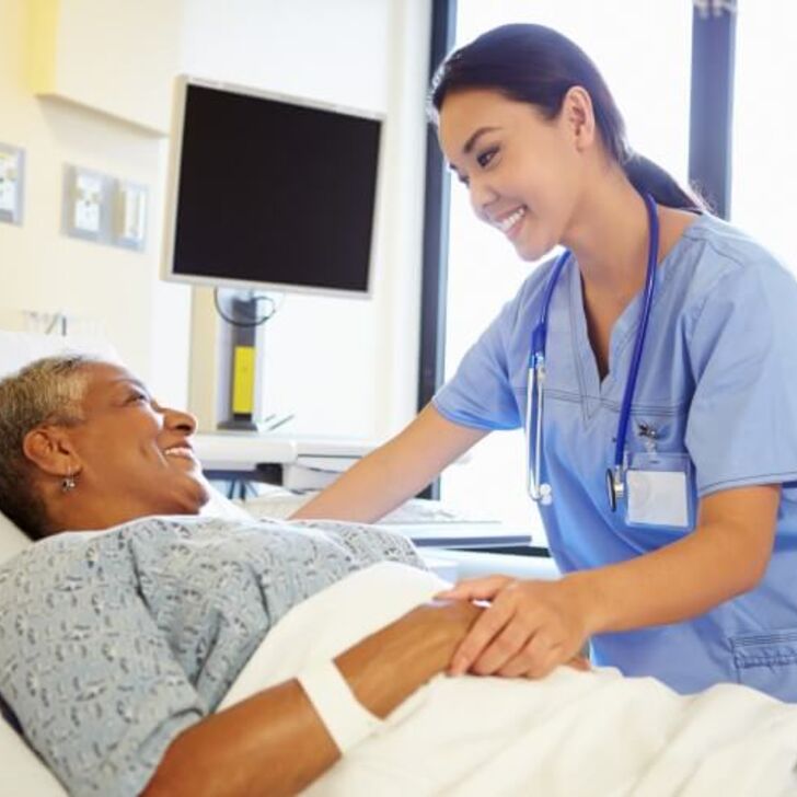 nurse-holds-hand-of-older-patient