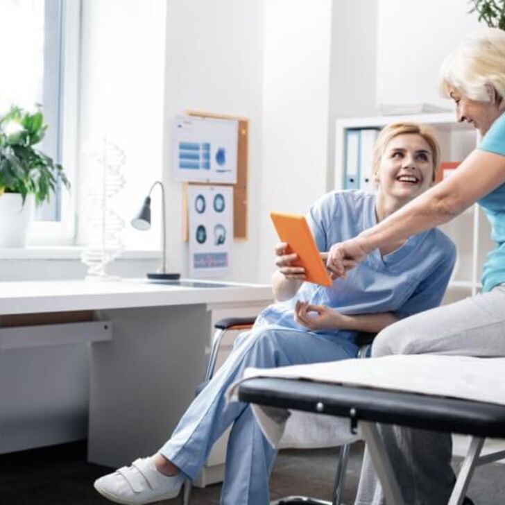 Nurse with patient looking at tablet