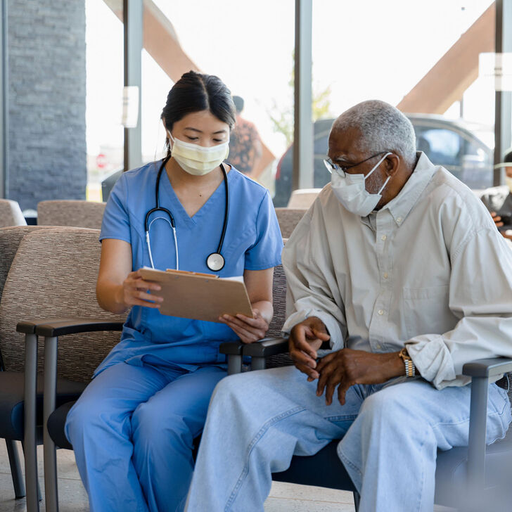 A triage nurse conversing with a patient